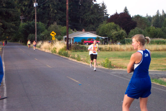 Jenn watches as Michelle kicks to the hand-off